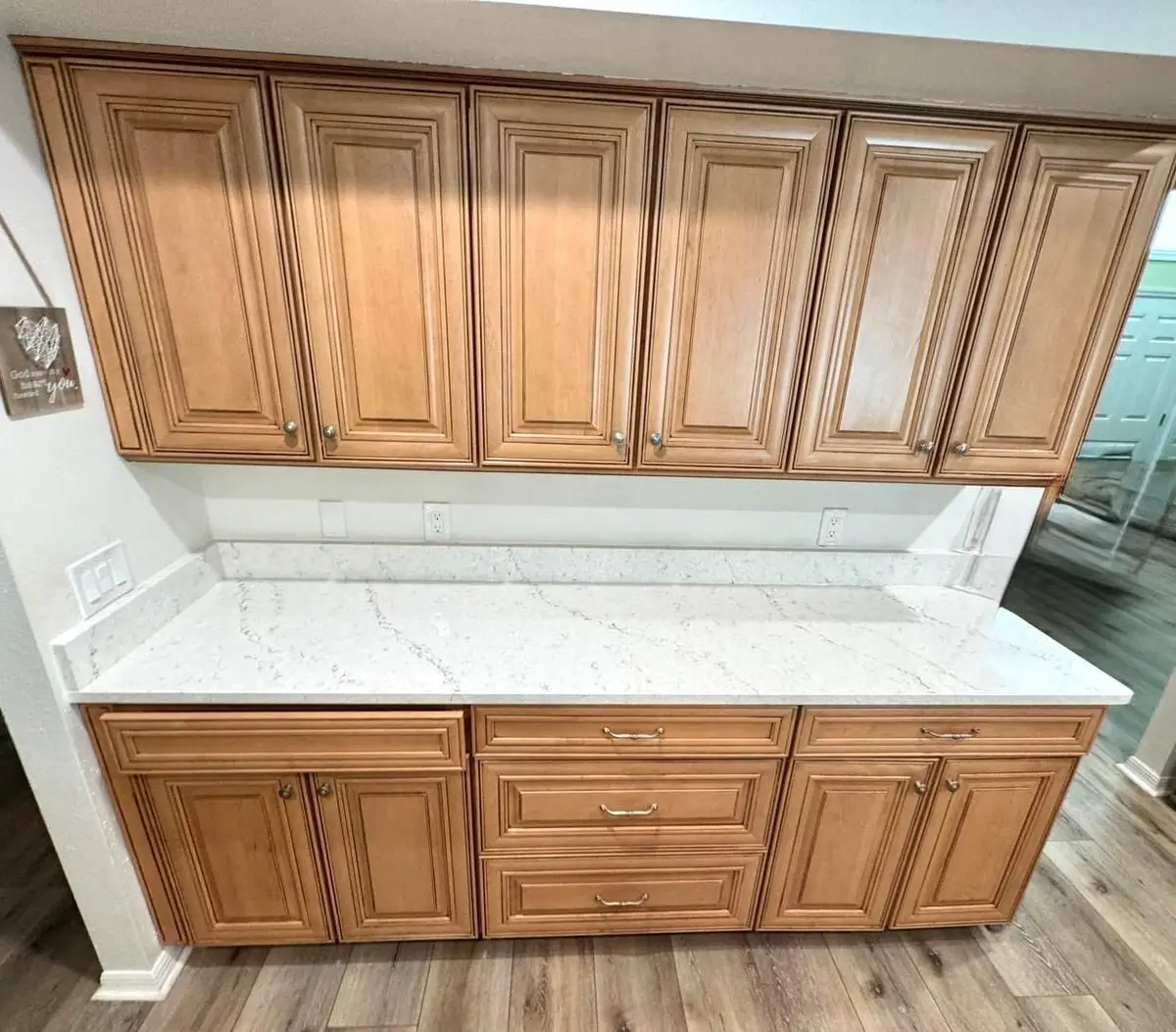 Oak kitchen cabinets with a new white veined quartz countertop
