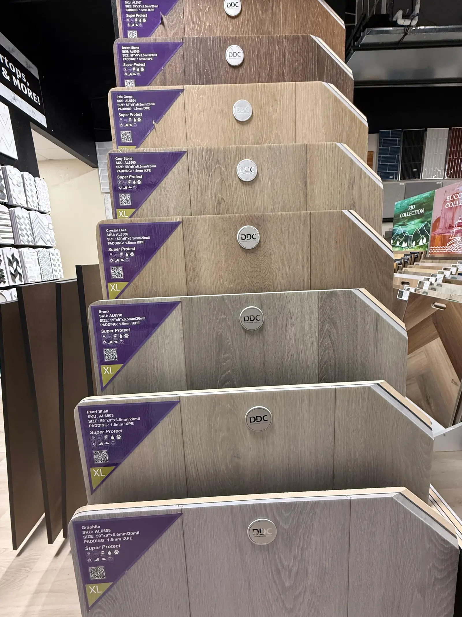Rigid core LVP plank samples in grey and wood tones