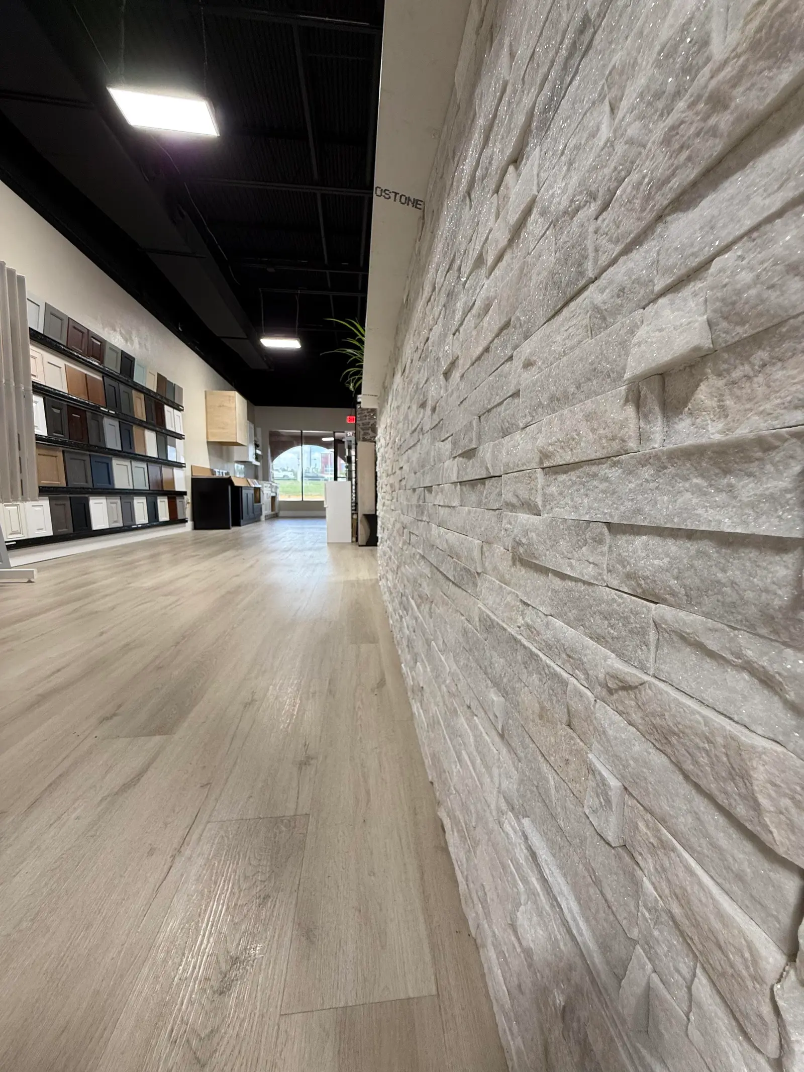 Ledgestone wall panel running the length of a showroom corridor