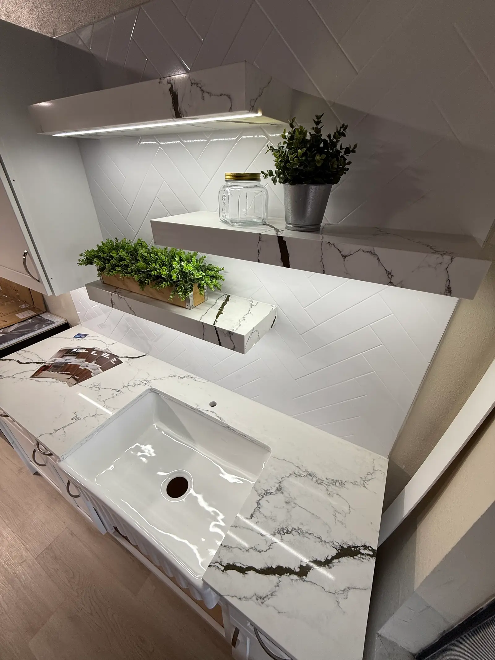 Quartz vanity top with an undermount sink and under-shelf lighting