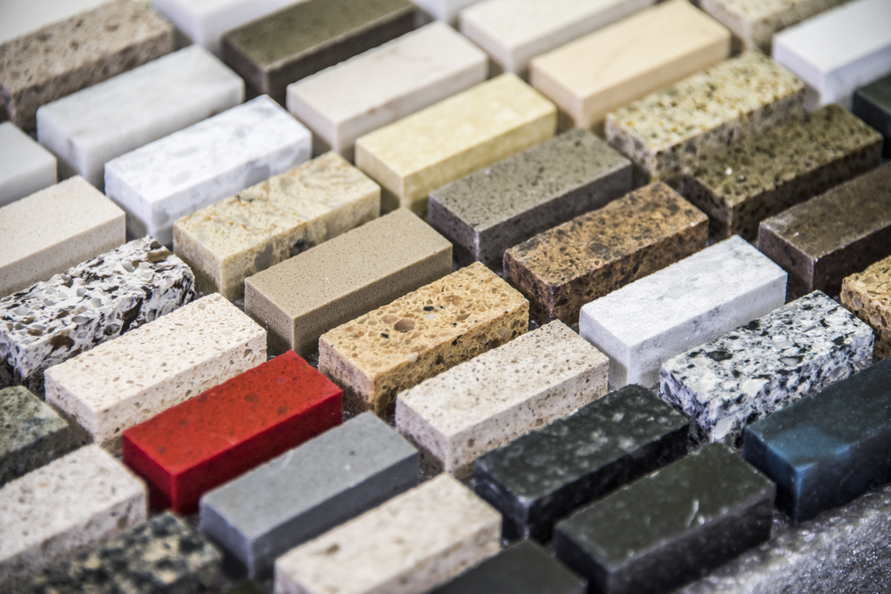 A variety of rectangular stone samples in different colors and textures are arranged in rows.