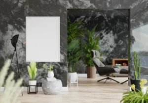 Modern luxury interior with a marble-patterned stone accent wall, potted plants, a blank framed picture, a black floor lamp, and a lounge chair near a bookcase.